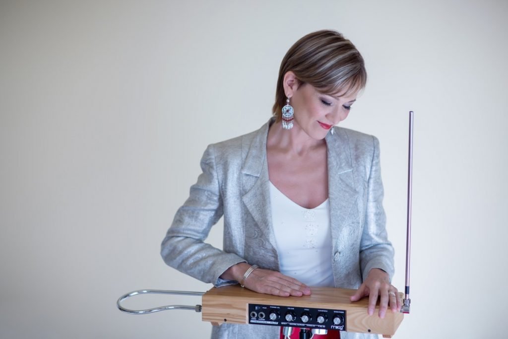 Lady playing theremin instrument